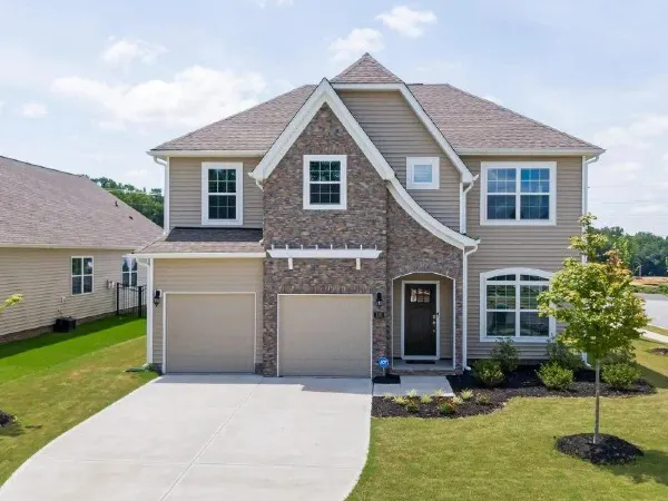 A house showing a very broad concrete driveway installed by TJ Concrete Contractor team in TX