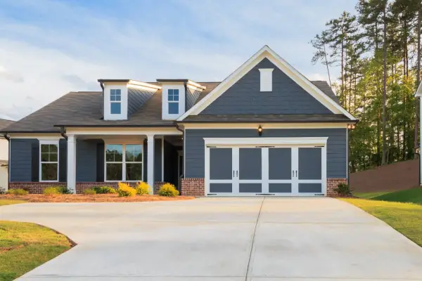 A house featuring a concrete driveway installed by TJ Concrete Contractor team in Cedar Park, TX
