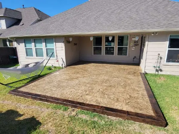A house in Cedar Park, TX featuring a stamped concrete patio built by the TJ Concrete Contractor team
